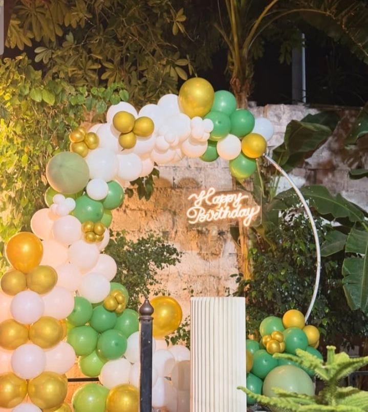 Jungle safari birthday theme with animal props and green foliage