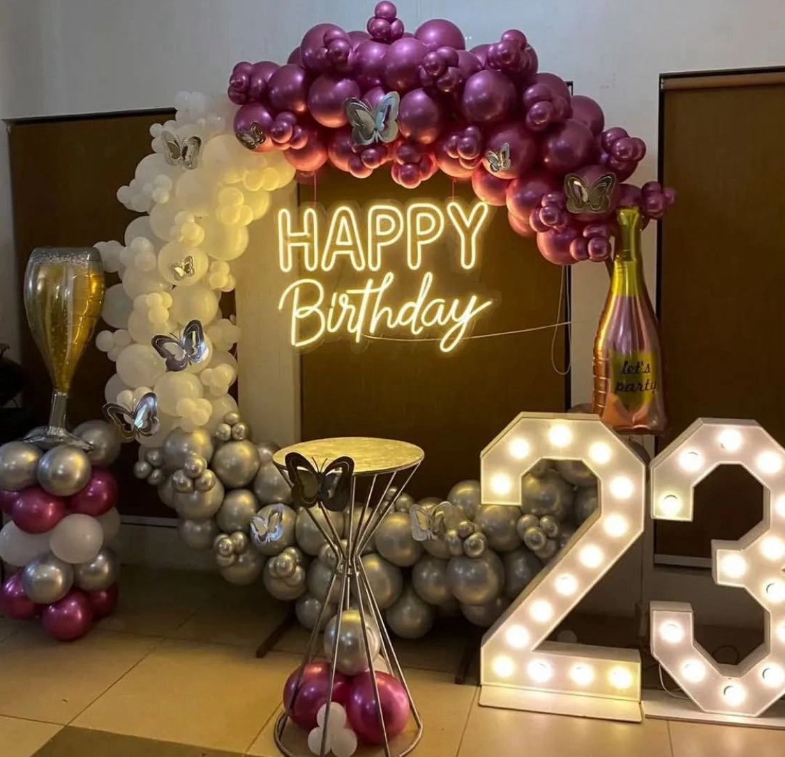 Carnival birthday setup with red-yellow booths and entertainers