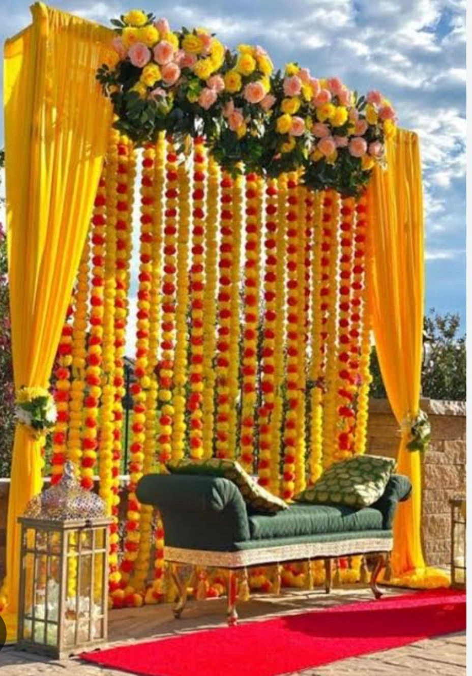 Haldi and Mehndi ceremony setup with floral backdrops and yellow theme